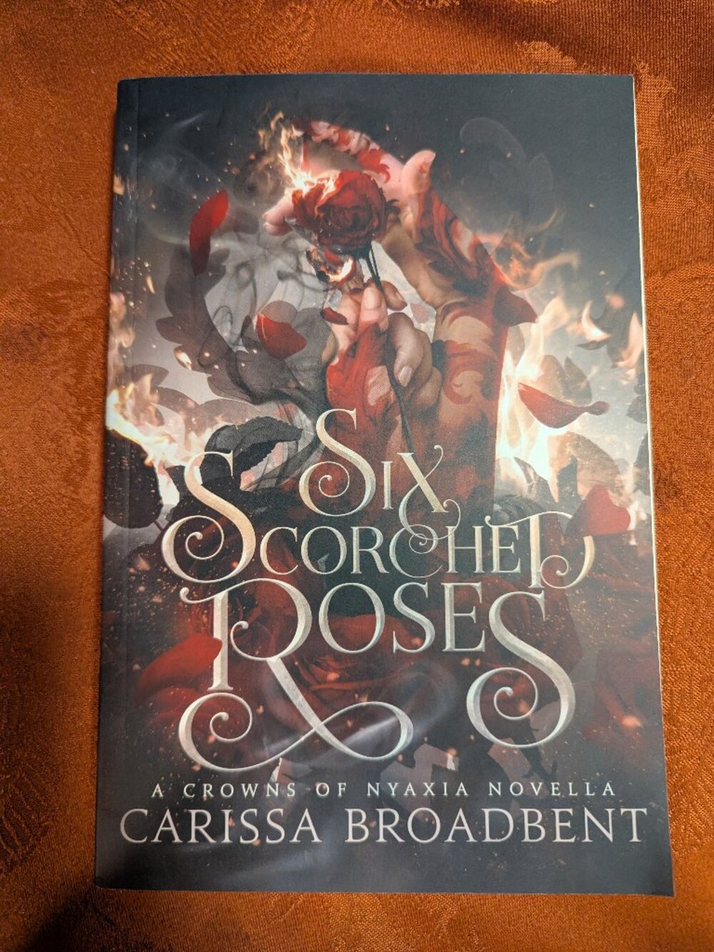 Crowns of Nyaxia, #1.5: Six Scorched Roses by Carissa Broadbent